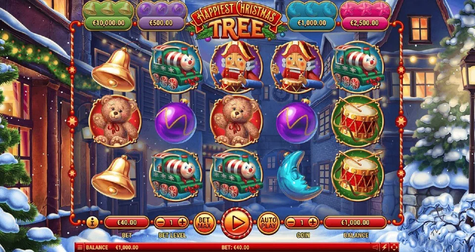 Happiest Christmas Tree base game: drums, trains, bells and baubles on five reels in front of a snowy street